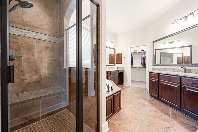 bathroom with crown molding, a shower with shower door, and vanity