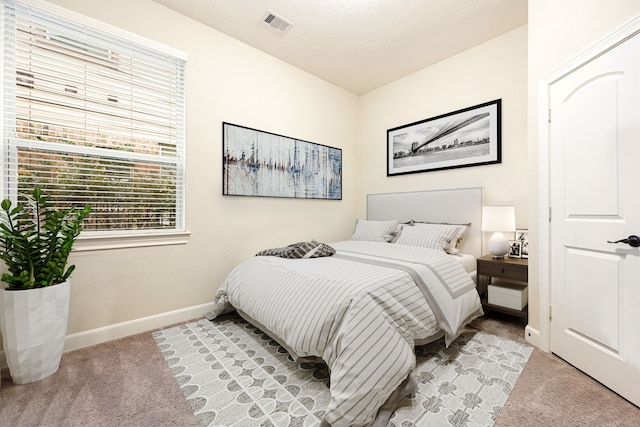 bedroom with light colored carpet