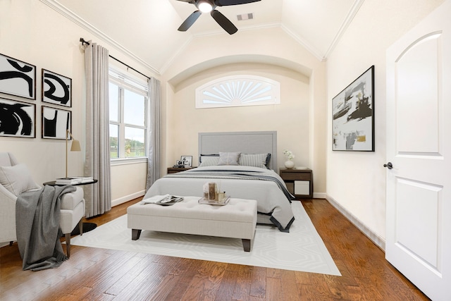 bedroom with ceiling fan, lofted ceiling, hardwood / wood-style floors, and crown molding