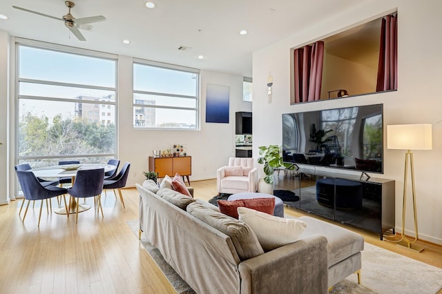 living room featuring ceiling fan and light wood-type flooring