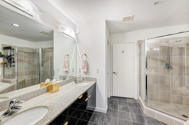 bathroom featuring tile patterned floors, a shower with door, and vanity