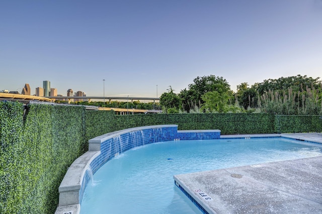 view of swimming pool with pool water feature