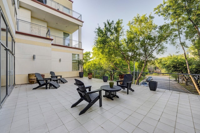 view of patio featuring a balcony