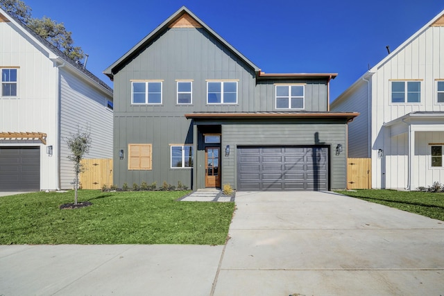 view of front of home featuring a front yard and a garage