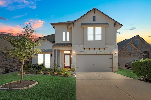 view of front of house featuring a yard and a garage