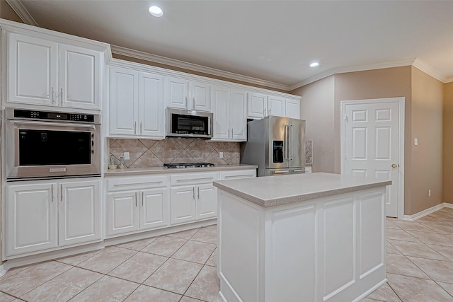 kitchen featuring white cabinetry, a center island, stainless steel appliances, and light tile patterned flooring