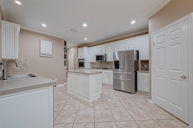 kitchen featuring light tile patterned floors, white cabinetry, stainless steel appliances, sink, and a center island