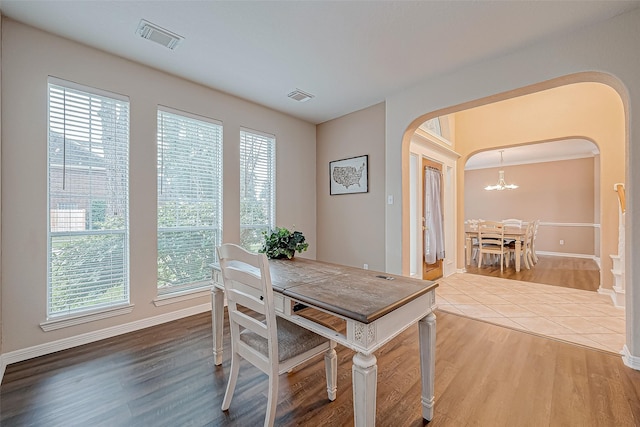 dining area with a chandelier and hardwood / wood-style floors