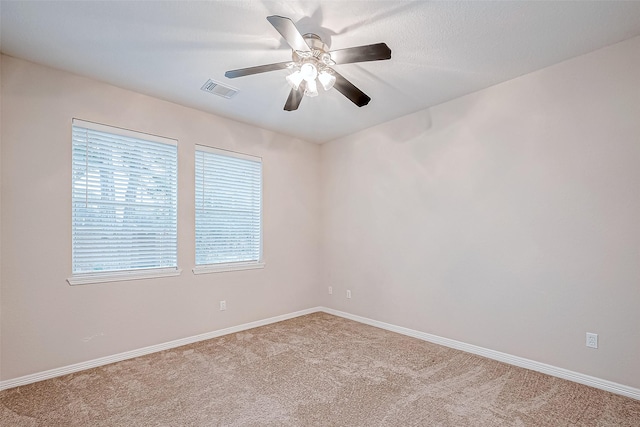 spare room featuring ceiling fan and light colored carpet