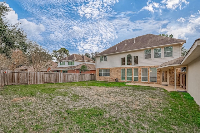 back of house with a lawn