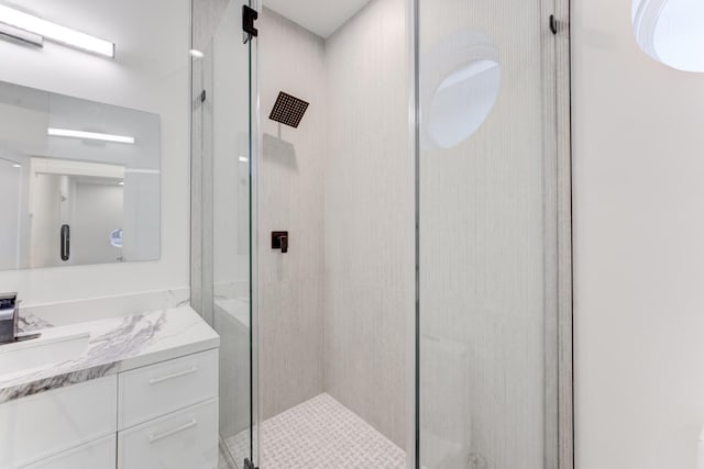 bathroom with vanity and a shower with door