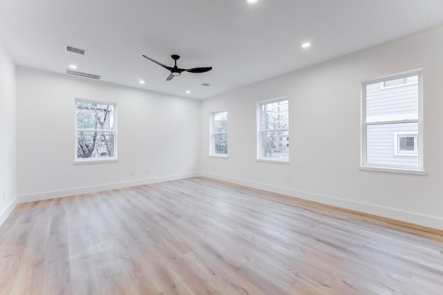 unfurnished room with ceiling fan, a healthy amount of sunlight, and light hardwood / wood-style floors