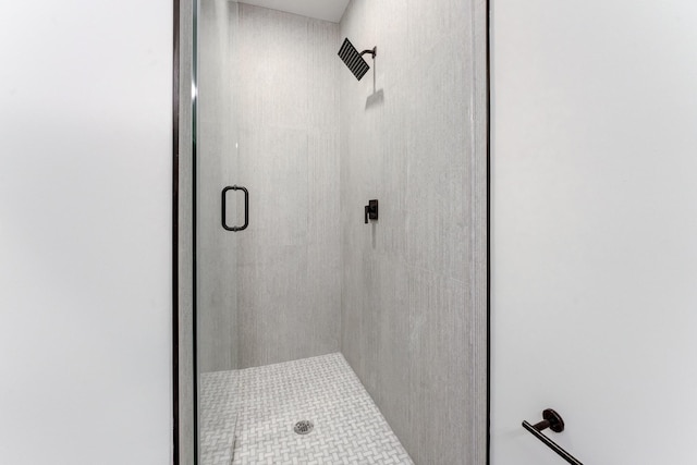 bathroom with a shower with door