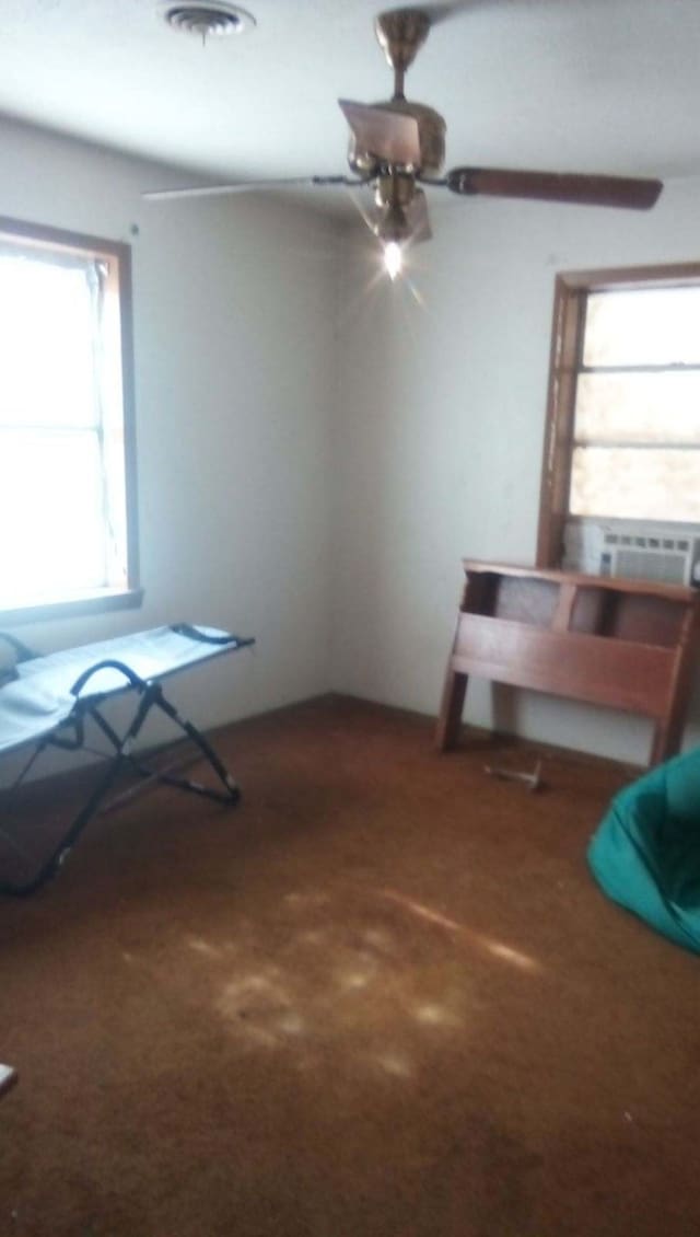 misc room with carpet floors and ceiling fan