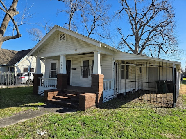 view of front of property with covered porch and a front lawn