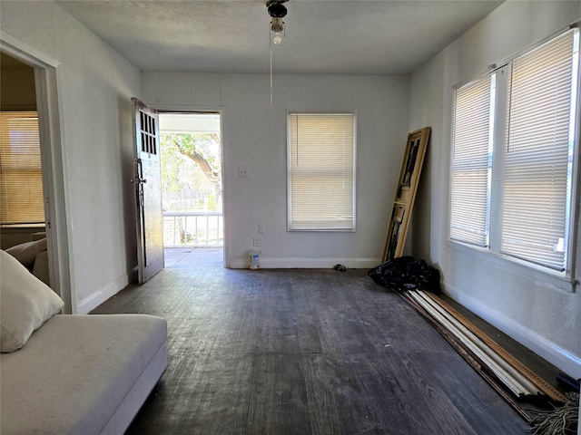 interior space featuring dark wood-style floors and baseboards