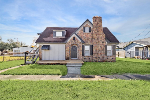 tudor house featuring a front yard