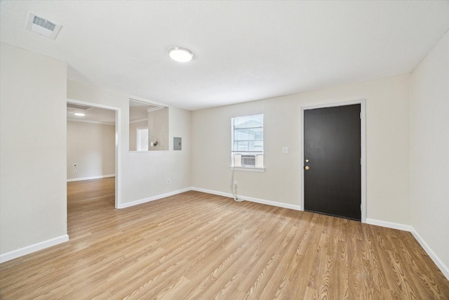 empty room with light hardwood / wood-style flooring