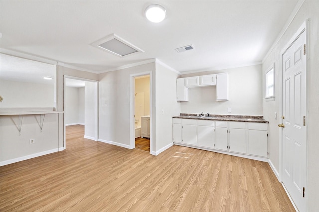 kitchen featuring crown molding, sink, light hardwood / wood-style flooring, and white cabinets