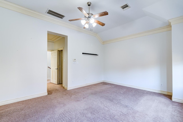 empty room with ceiling fan, light colored carpet, vaulted ceiling, and ornamental molding