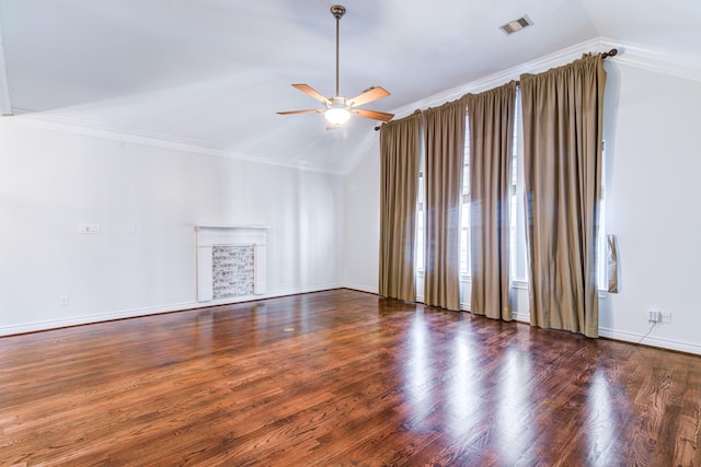 empty room featuring lofted ceiling, dark hardwood / wood-style floors, and ornamental molding