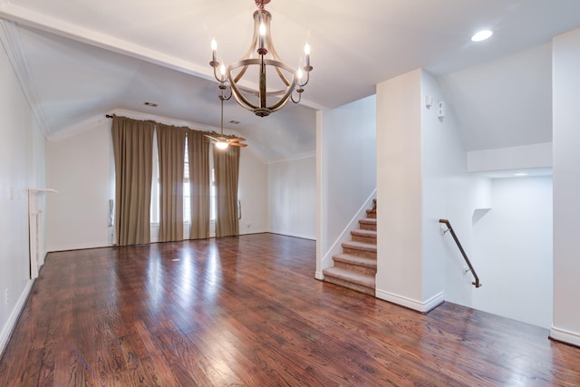 spare room featuring lofted ceiling, dark wood-type flooring, crown molding, and a chandelier