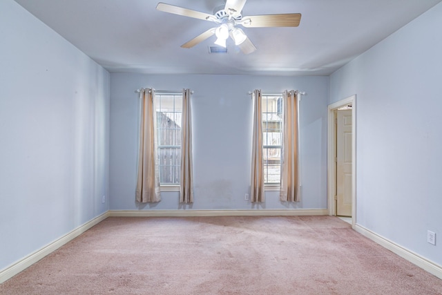 unfurnished room featuring light carpet, a healthy amount of sunlight, and ceiling fan