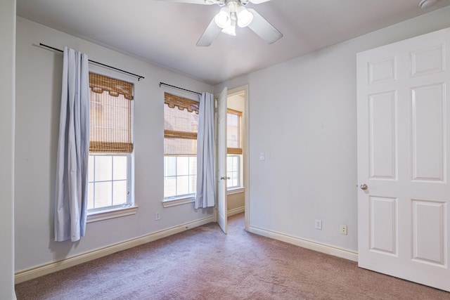 unfurnished room featuring light carpet and ceiling fan