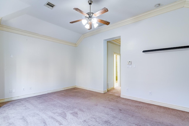 spare room with ceiling fan, light colored carpet, and crown molding