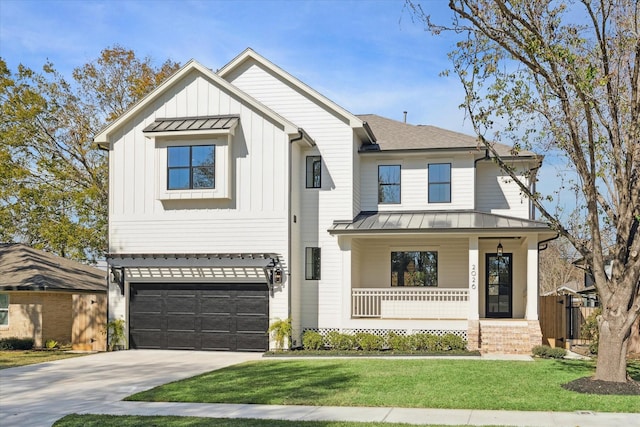 modern farmhouse style home with a front yard, covered porch, and a garage