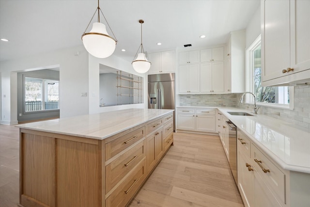 kitchen with a spacious island, white cabinets, and stainless steel appliances