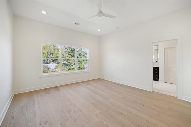 spare room featuring ceiling fan and light hardwood / wood-style flooring