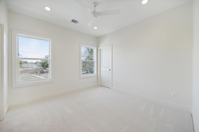 carpeted empty room with ceiling fan and a healthy amount of sunlight