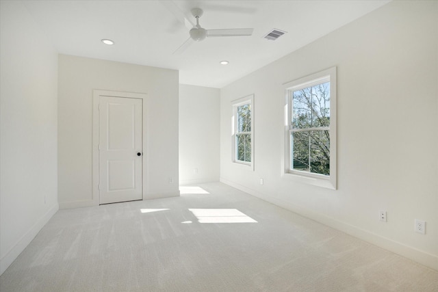 carpeted spare room with ceiling fan