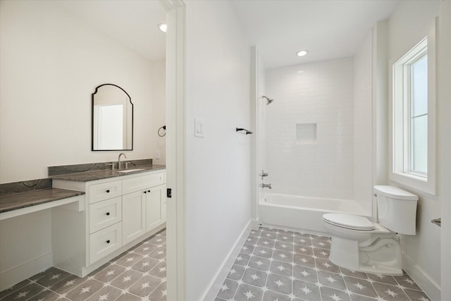 full bathroom with toilet, vanity, and tiled shower / bath combo