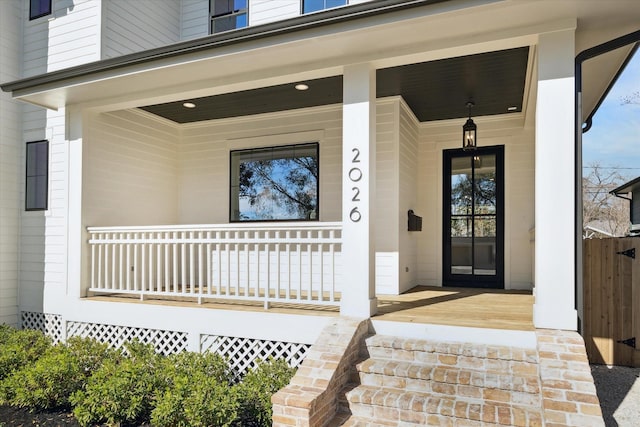 view of exterior entry featuring a porch