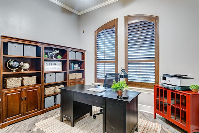 office with light wood-type flooring and ornamental molding