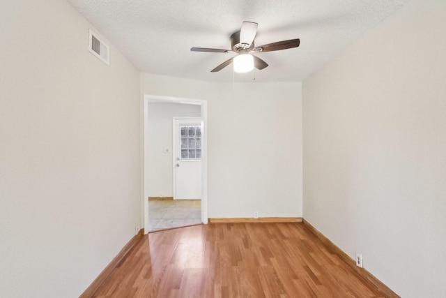 unfurnished room featuring ceiling fan, a textured ceiling, and light hardwood / wood-style floors