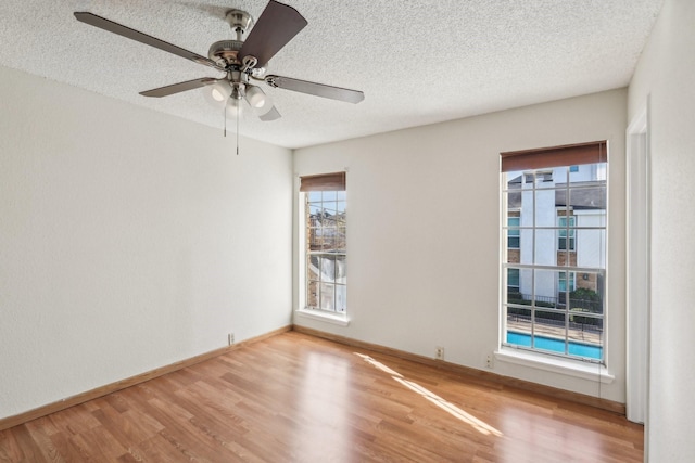 unfurnished room featuring hardwood / wood-style flooring, a textured ceiling, and ceiling fan