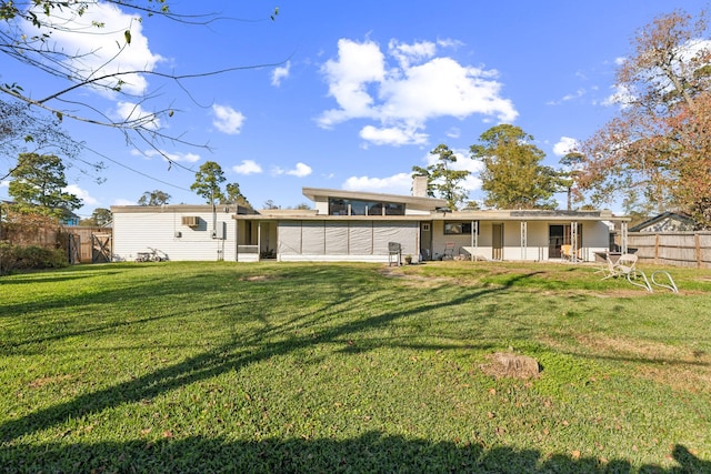 back of house featuring a yard