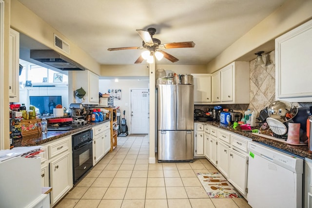 kitchen featuring backsplash, appliances with stainless steel finishes, dark stone counters, and white cabinetry