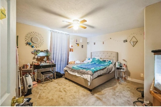 carpeted bedroom featuring a textured ceiling and ceiling fan