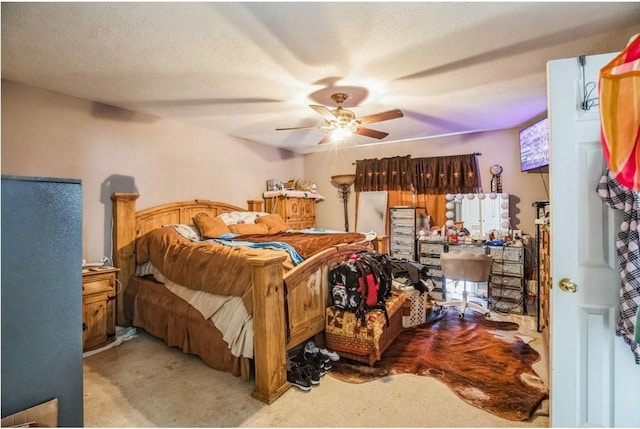 carpeted bedroom with ceiling fan and a textured ceiling