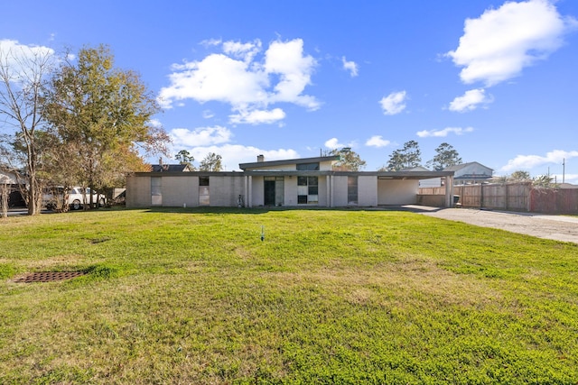 view of front of property with a front lawn and a carport