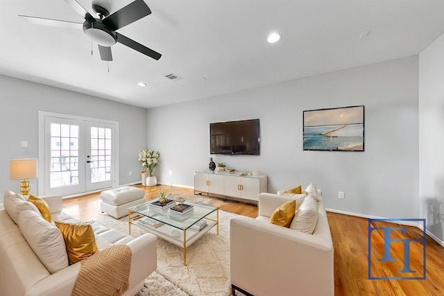 living room with ceiling fan, wood-type flooring, and french doors