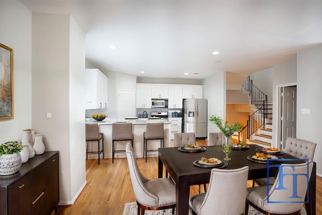 dining space featuring light wood-type flooring