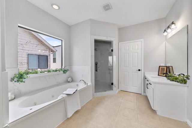 bathroom featuring shower with separate bathtub, tile patterned floors, and vanity