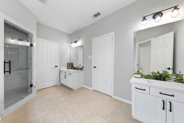 bathroom with tile patterned flooring, walk in shower, and vanity