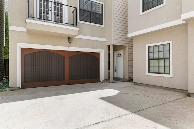 doorway to property featuring a garage and a balcony