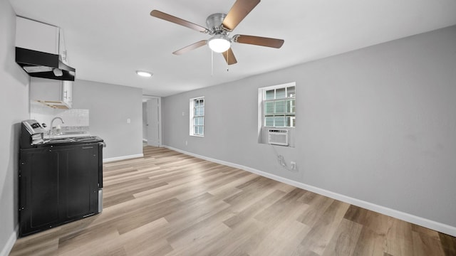 living room featuring ceiling fan, cooling unit, light hardwood / wood-style flooring, and sink